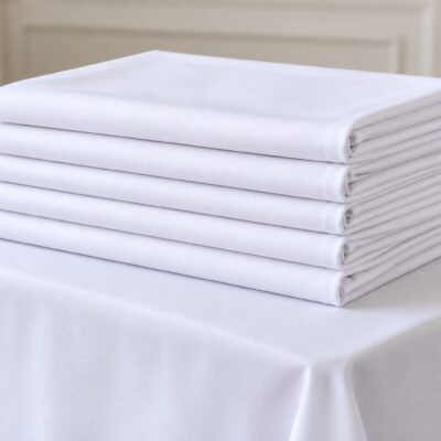 Folded white rental table linens